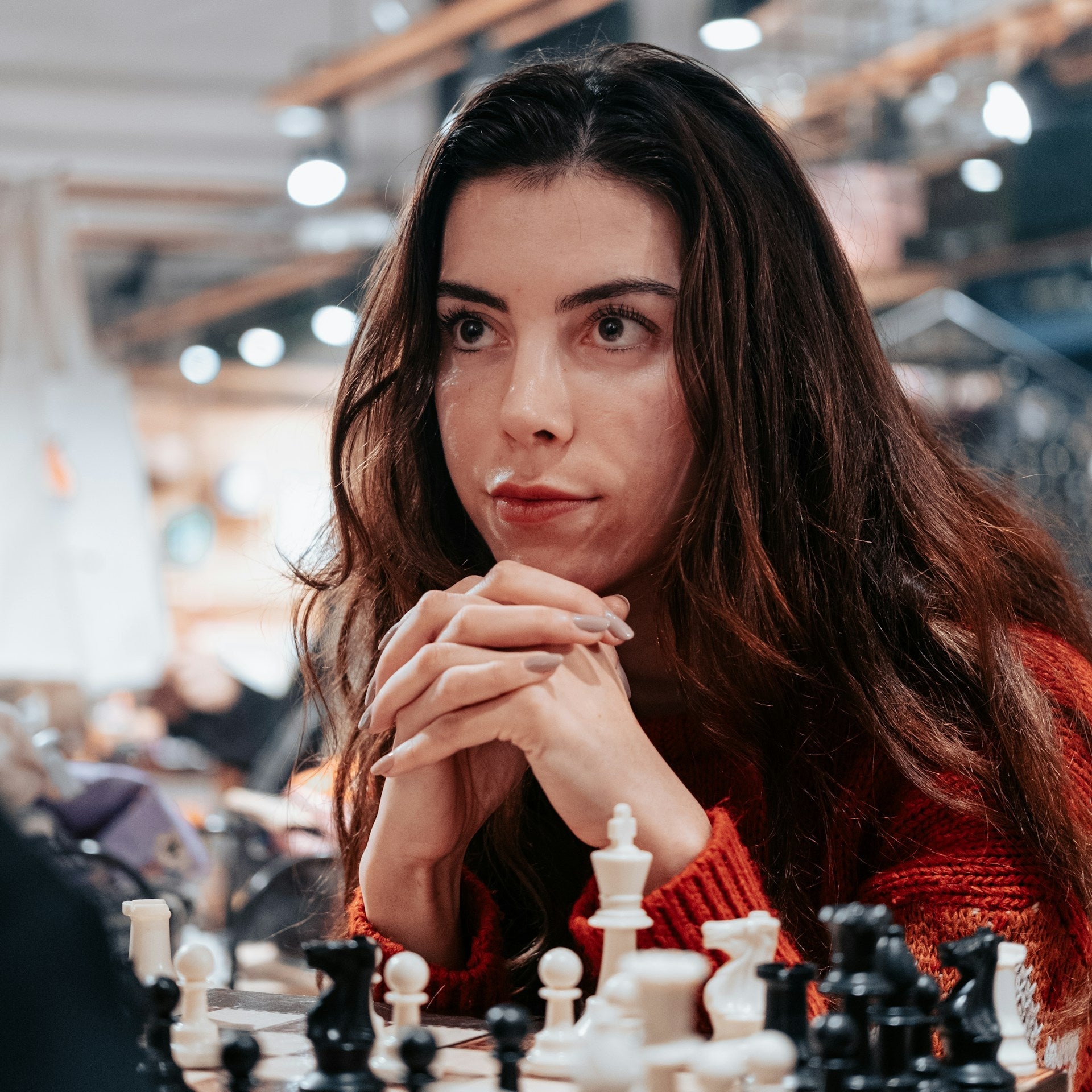 Woman playing chess in a store setting